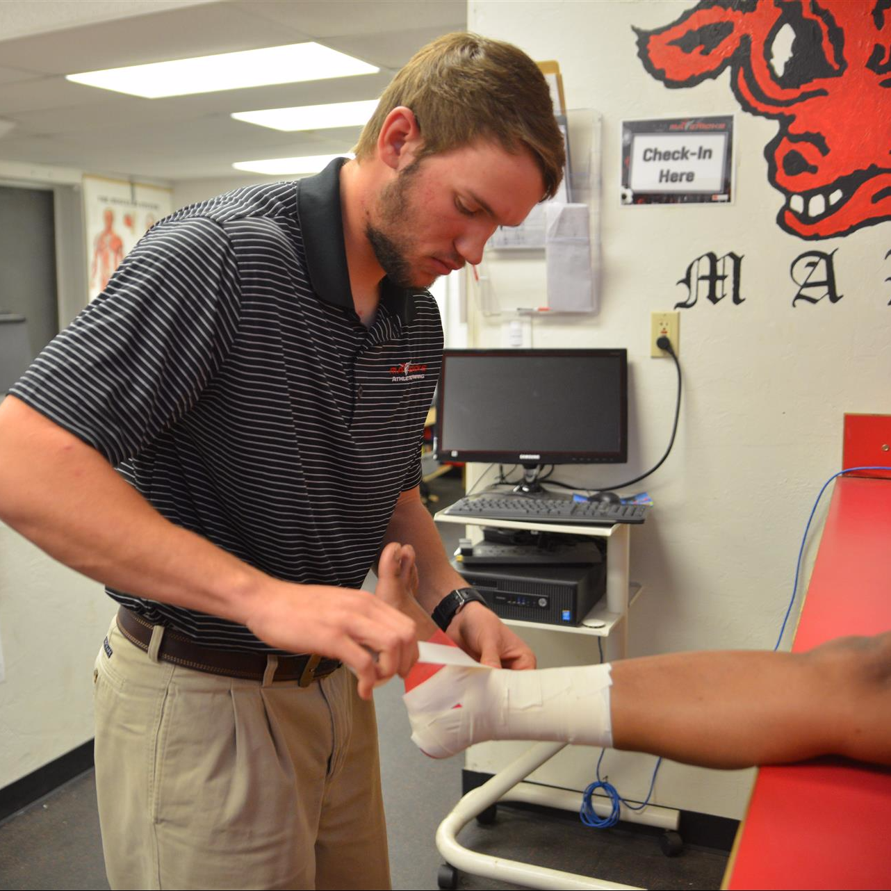 Paden Morris taping an ankle